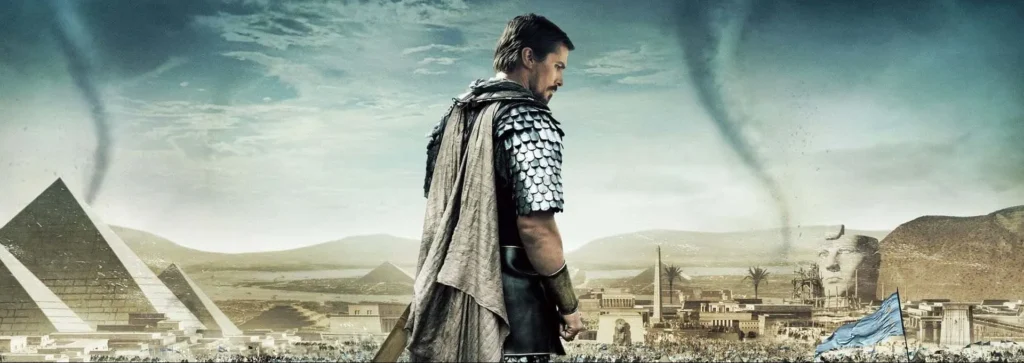 A cinematic scene of epic proportions from the movie “Exodus: Gods and Kings” (2014). It features a lone warrior overlooking an ancient Egyptian landscape. The warrior, dressed in a textured cape and metal scale armor, stands with his back to the viewer, facing a sprawling view of pyramids and a bustling ancient city. A dramatic sky looms above, with swirling clouds and a hint of a tornado in the distance. This powerful imagery evokes a sense of impending action and the weight of historical destiny.