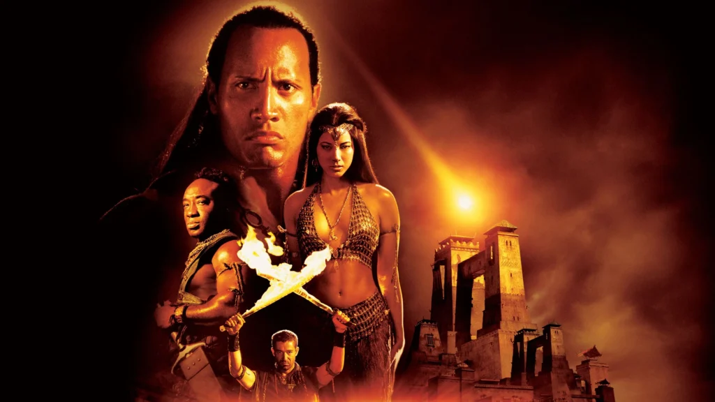 The central figure is a muscular man, looking directly at the viewer with a serious expression, indicative of his leading role in the action and plot of the movie “The Scorpion King” (2002). Flanking him are a male character wielding a bow and arrow, and a female character holding a flaming torch, both adorned in detailed, historically appropriate costumes. Behind them, the silhouette of a majestic castle under a fiery sunset adds a dramatic and mystical element to the scene. The rich orange and red tones of the image evoke a sense of danger and urgency.